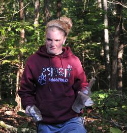 Morgan Cubert, a junior cheerleader from Lawrenceburg, Ky., picks up trash at the lake cleanup. (Campbellsville University photo by Courtney Drury)